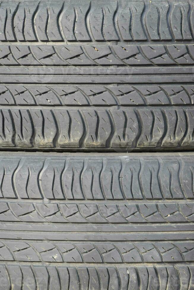 The background of the tread pattern of the car wheel. Rubber tir photo