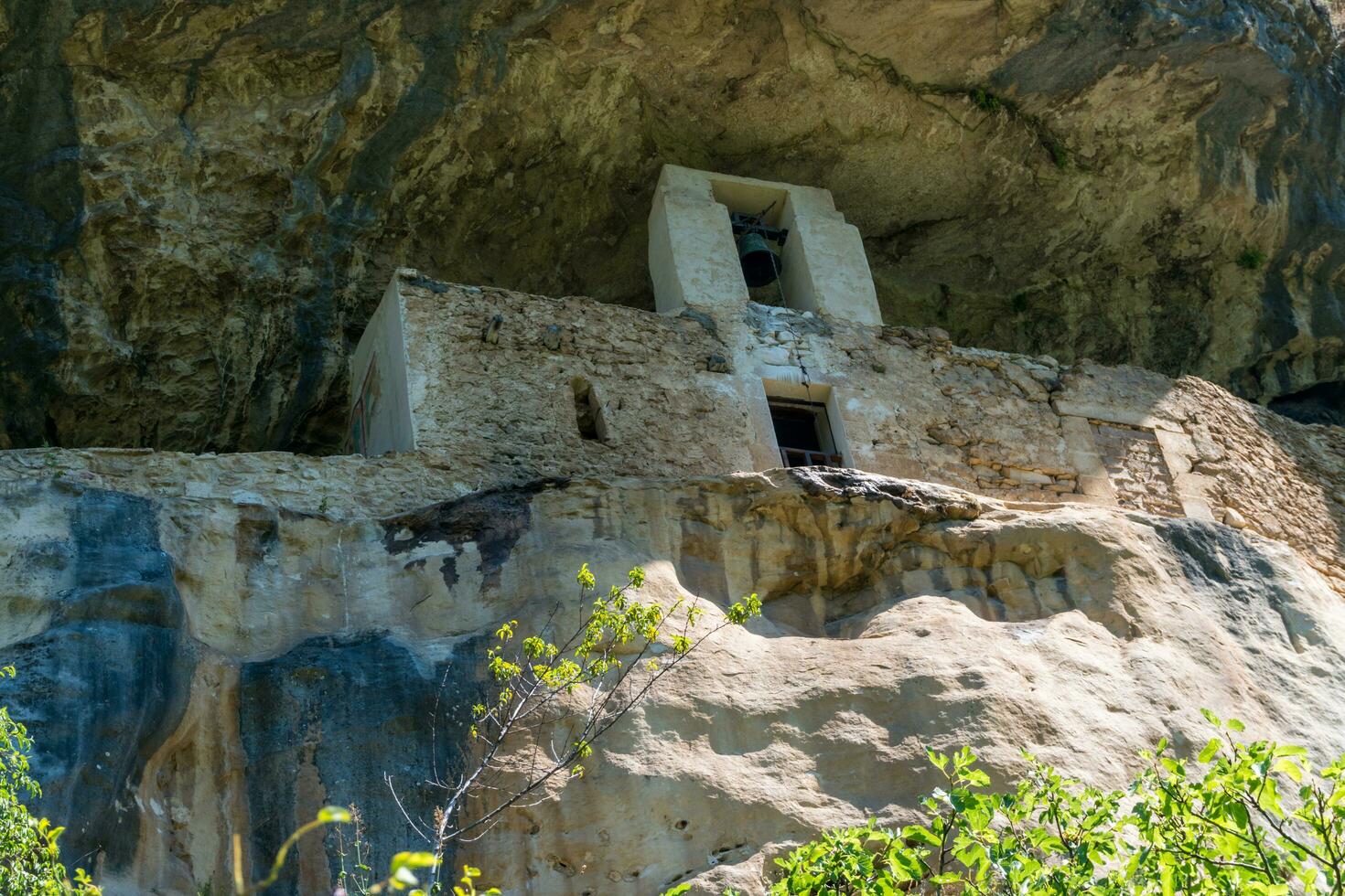 L'Aquila, Italy-august 12, 2021-Hermitage of San Bartolomeo an ancient church dug into a cliff with a well-preserved fresco, altar and hermit's cells. photo