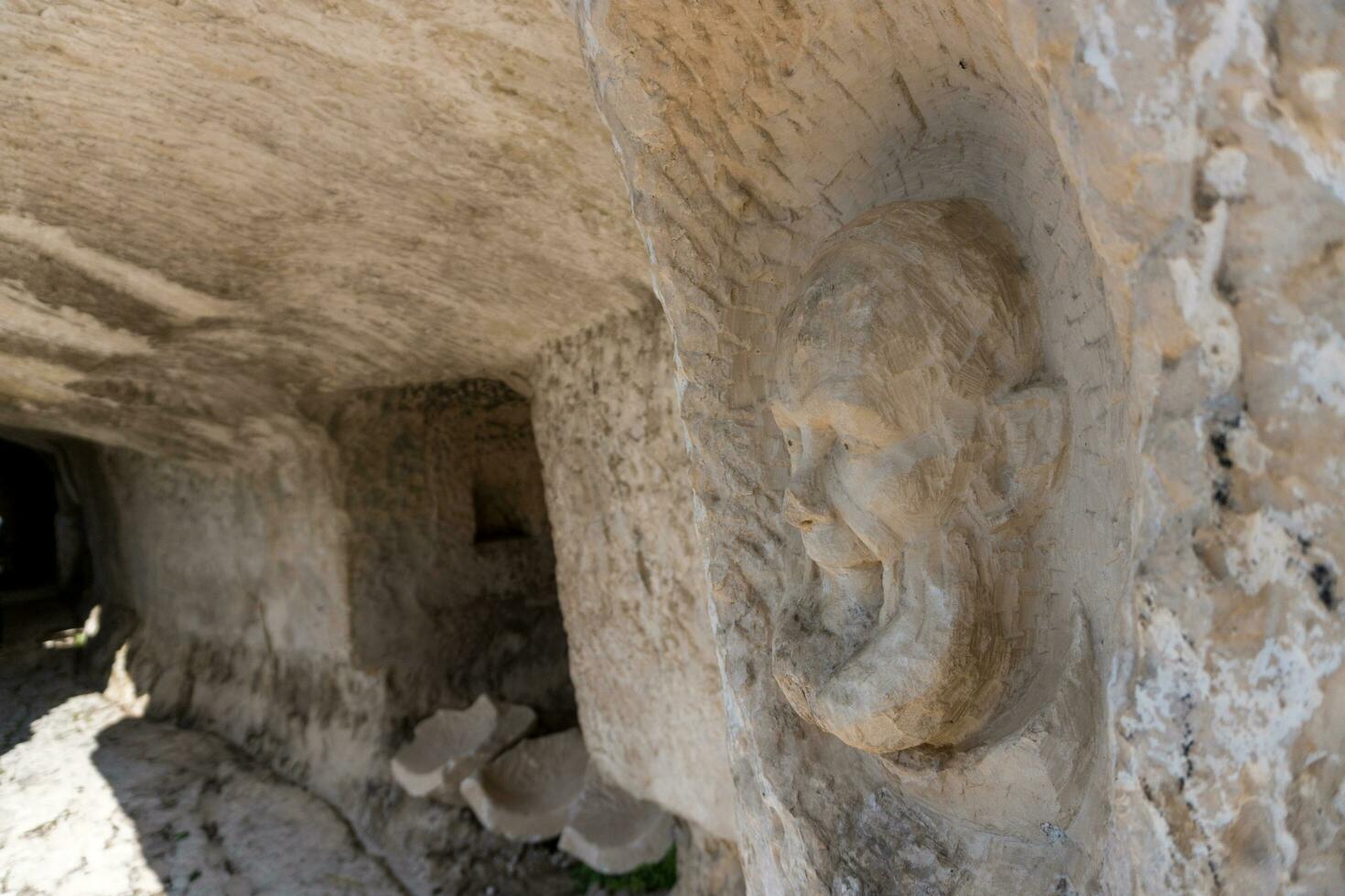 L'Aquila, Italy-august 12, 2021-ruins of the Hermitage of the Holy Spirit an ancient church dug into a cliff with a well-preserved fresco, altar and hermit's cells. photo