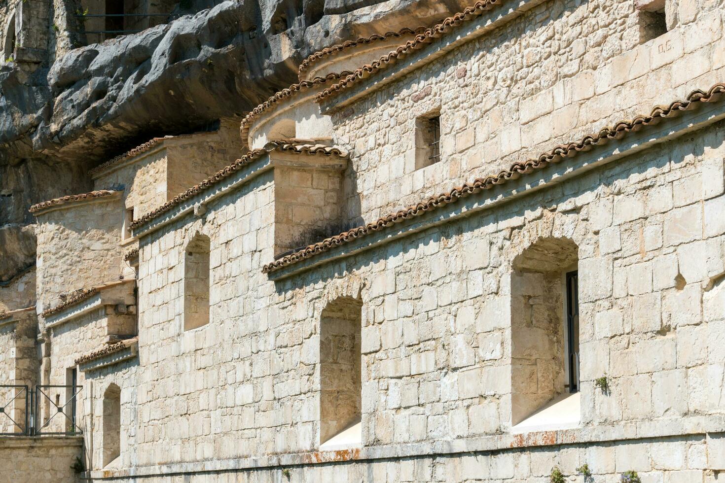 L'Aquila, Italy-august 12, 2021-Hermitage of the Holy Spirit an ancient church dug into a cliff with a well-preserved fresco, altar and hermit's cells. photo
