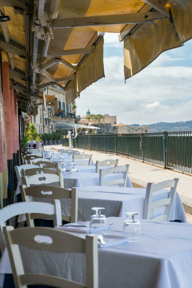 Syracuse, Italy-May 9, 2022-View of the famous pedestrian route located on the Alfeo seafront in Syracuse during a sunny day photo