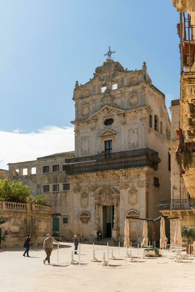 Syracuse, Italy-May 9, 2022-View of the Church of Santa Lucia alla Badia in the cathedral square during a sunny day photo