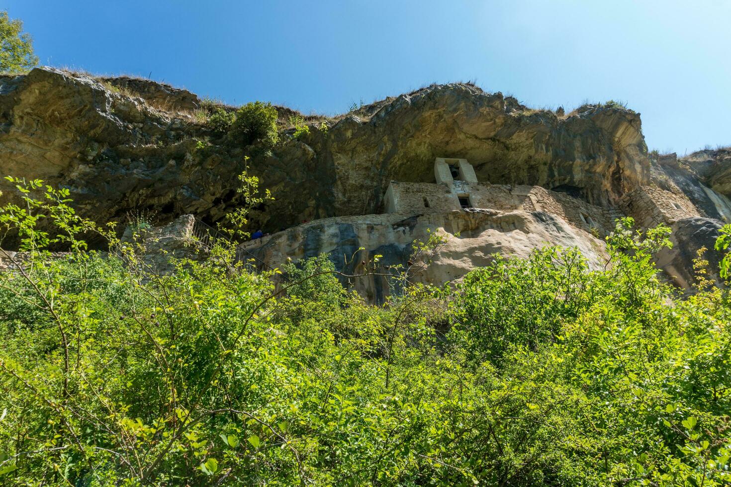 L'Aquila, Italy-august 12, 2021-Hermitage of San Bartolomeo an ancient church dug into a cliff with a well-preserved fresco, altar and hermit's cells. photo