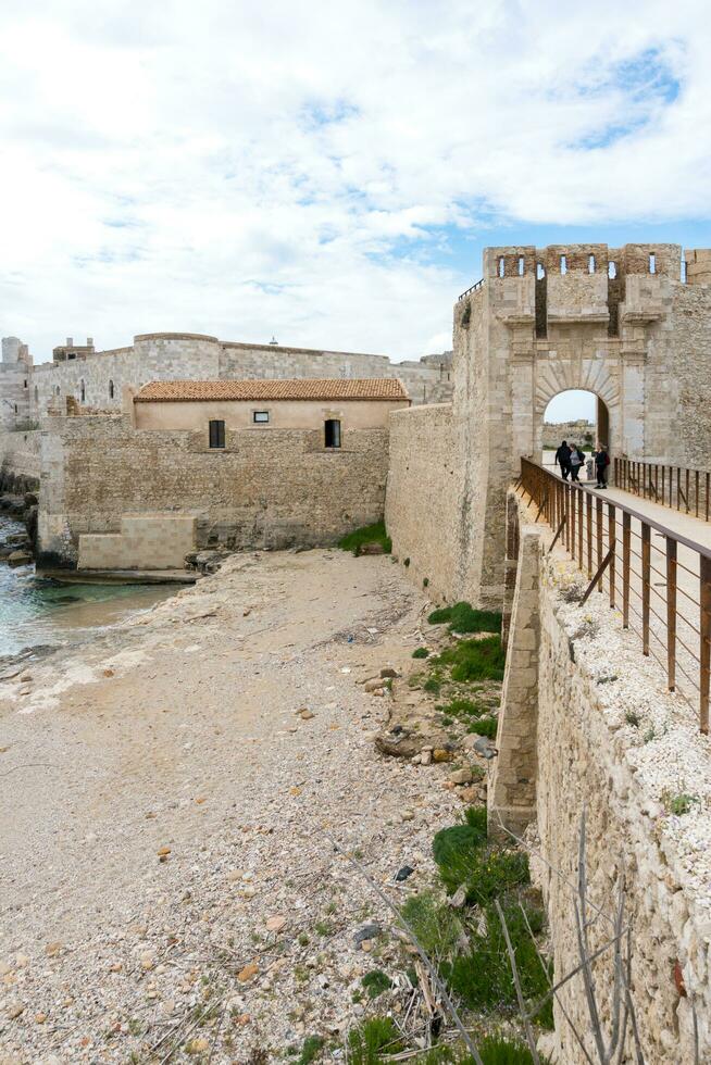 Syracuse, Italy-May 9, 2022-people visit the famous Maniace Castle on the island of Ortigia in Syracuse during a sunny day photo