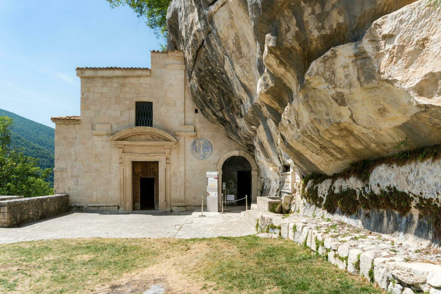 L'Aquila, Italy-august 12, 2021-Hermitage of the Holy Spirit an ancient church dug into a cliff with a well-preserved fresco, altar and hermit's cells. photo