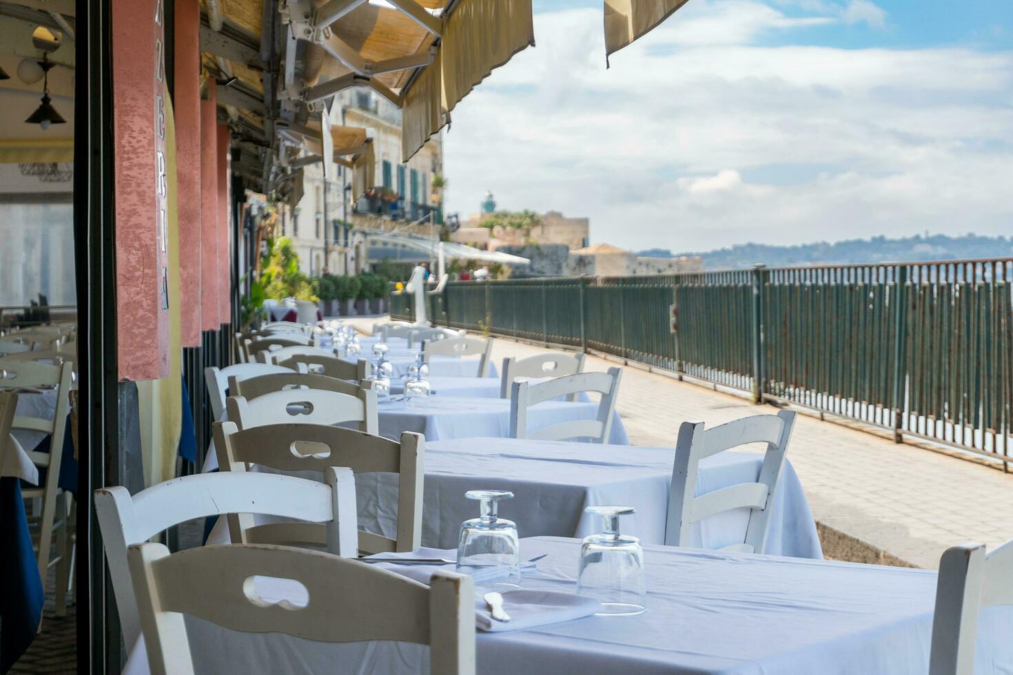 Syracuse, Italy-May 9, 2022-View of the famous pedestrian route located on the Alfeo seafront in Syracuse during a sunny day photo