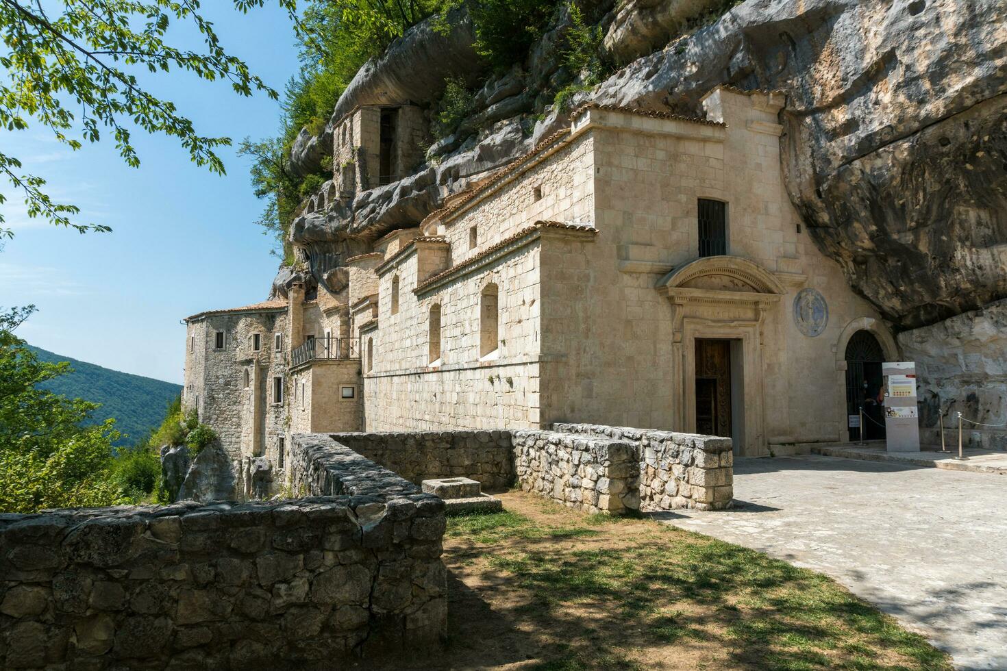 L'Aquila, Italy-august 12, 2021-Hermitage of the Holy Spirit an ancient church dug into a cliff with a well-preserved fresco, altar and hermit's cells. photo