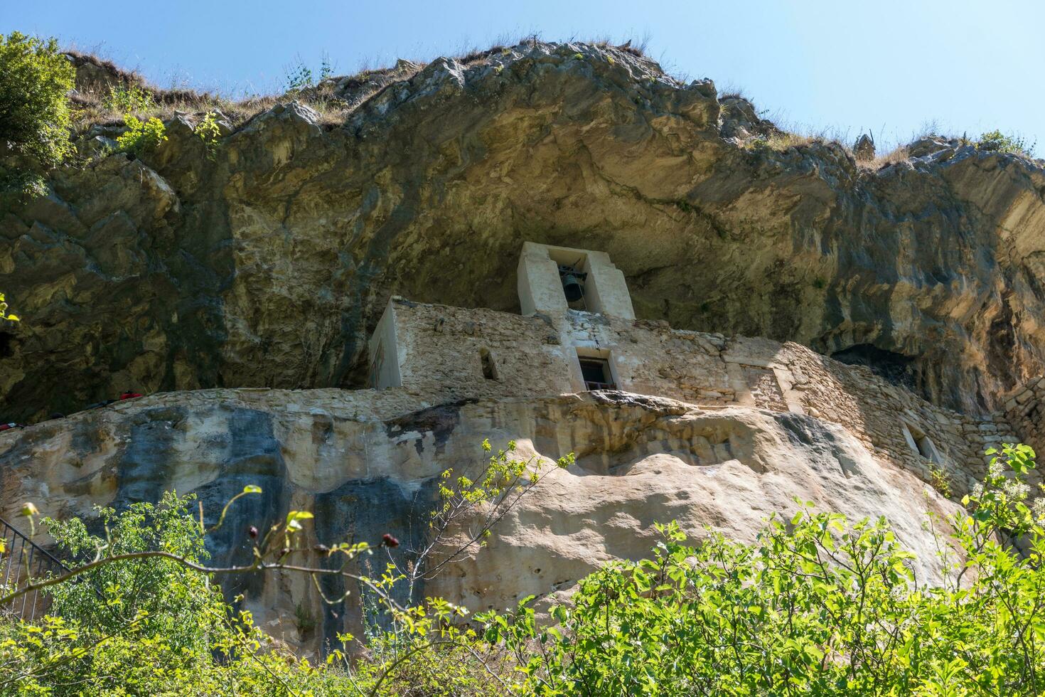 L'Aquila, Italy-august 12, 2021-Hermitage of San Bartolomeo an ancient church dug into a cliff with a well-preserved fresco, altar and hermit's cells. photo