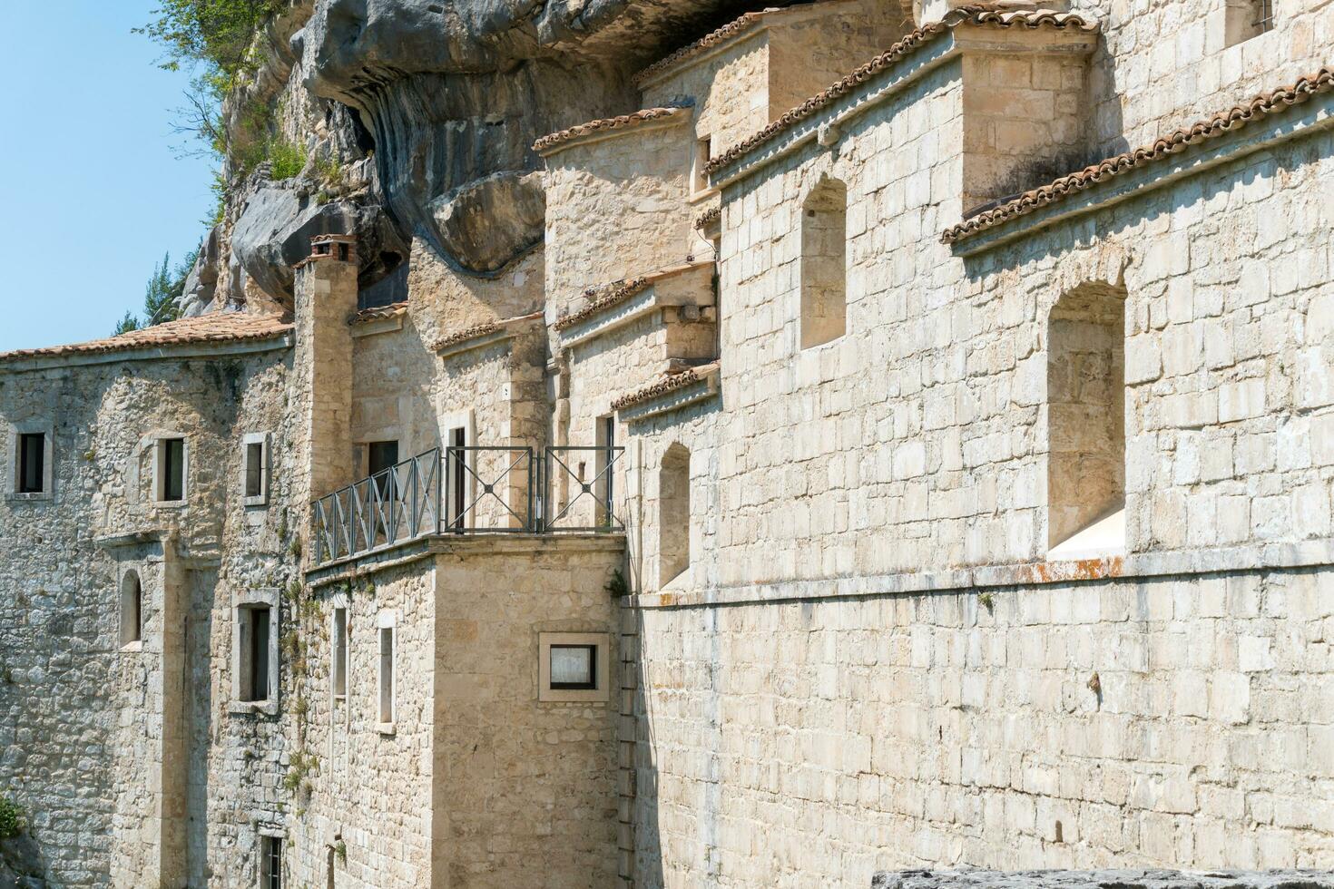 L'Aquila, Italy-august 12, 2021-Hermitage of the Holy Spirit an ancient church dug into a cliff with a well-preserved fresco, altar and hermit's cells. photo