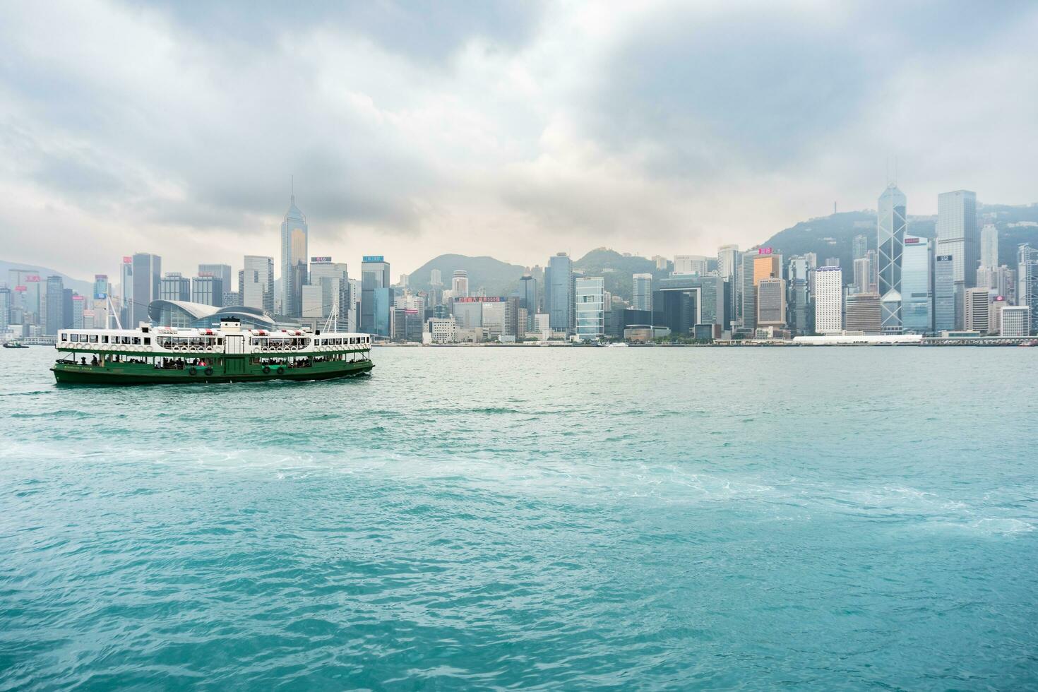 Hong Kong,March 27, 2019-View of the Hong Kong skyscrapers from the ferrie crossing the Victoria Harbour during a cloudy day photo