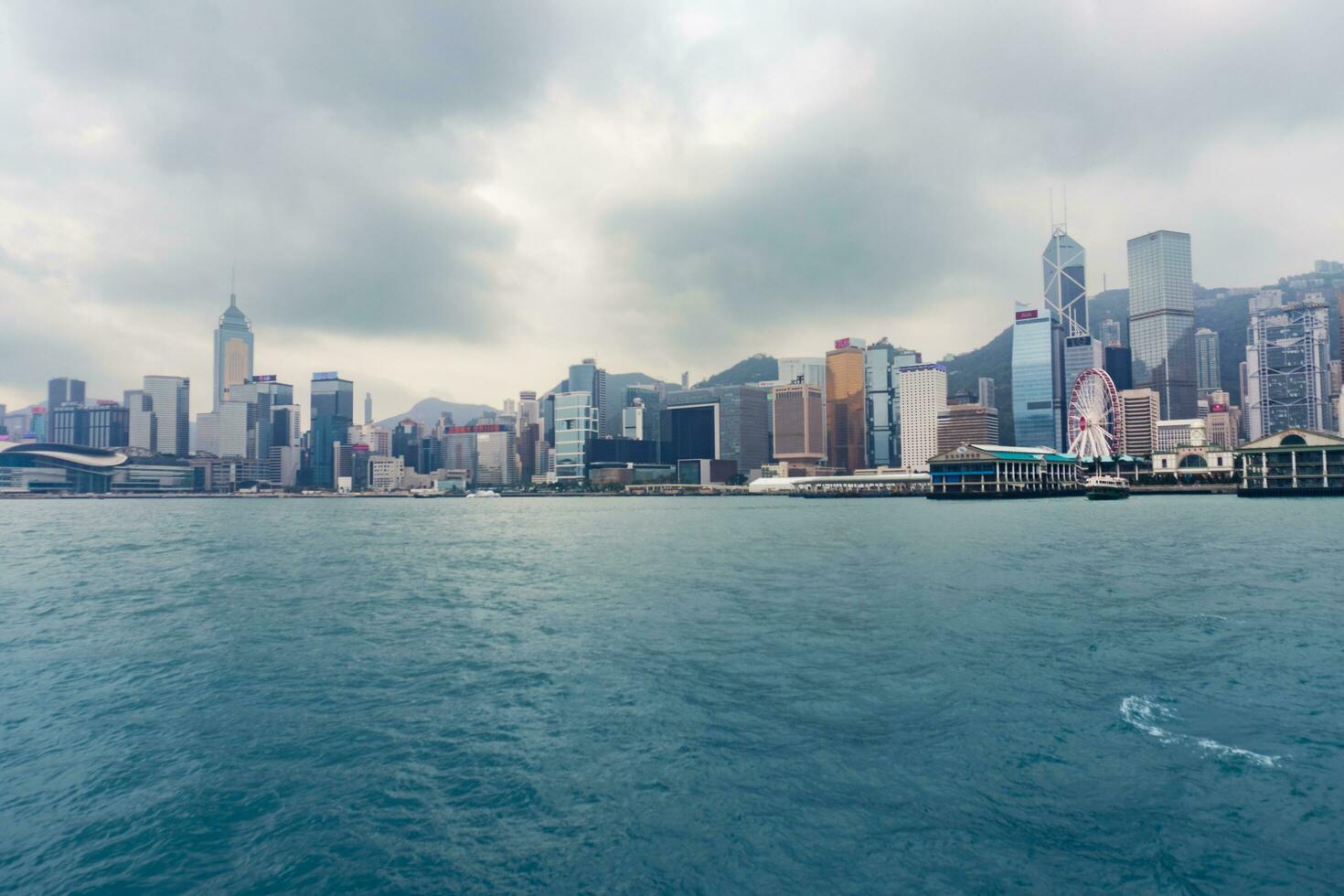 Hong Kong,March 27, 2019-View of the Hong Kong skyscrapers from the ferrie crossing the Victoria Harbour during a cloudy day photo