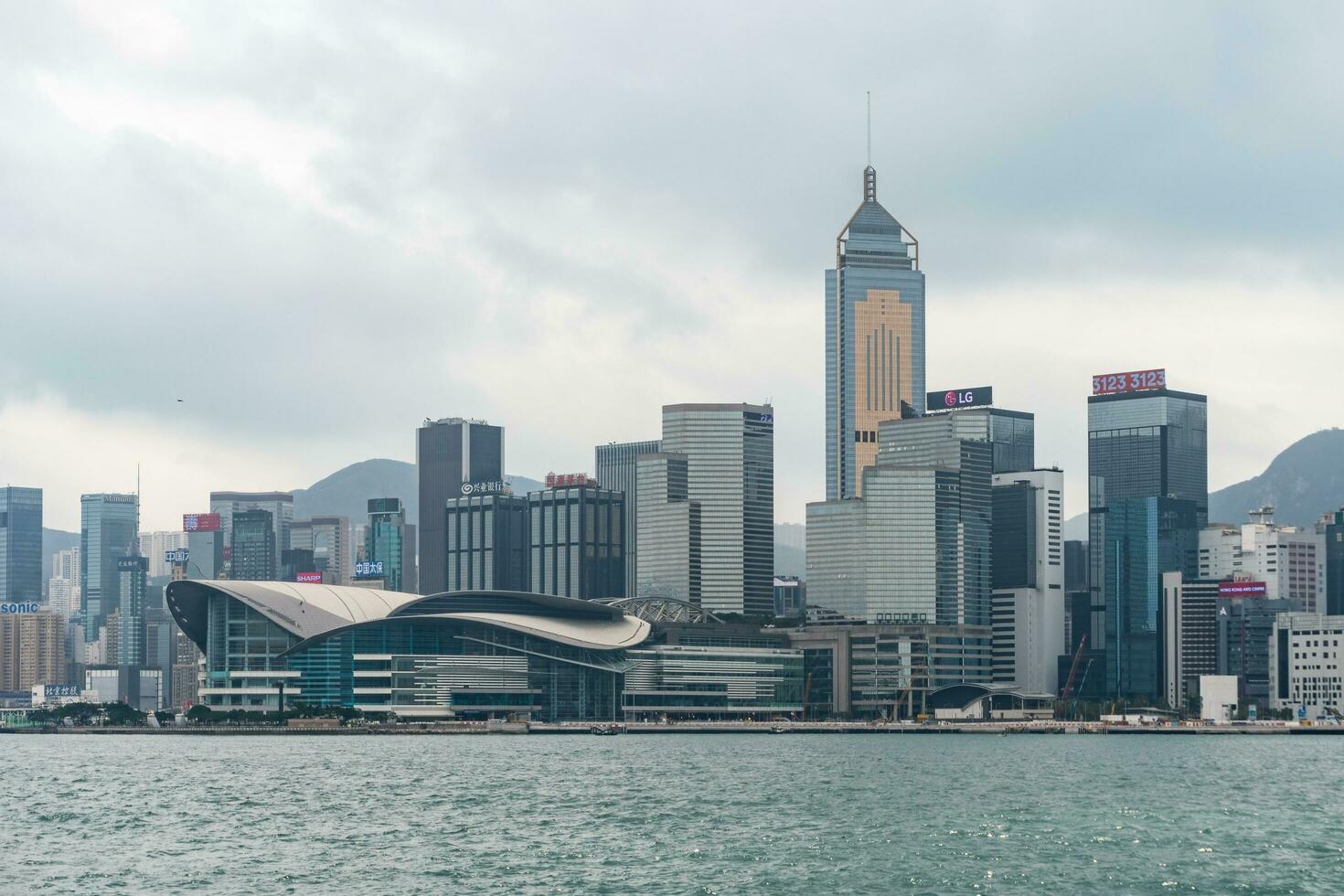 Hong Kong,March 27, 2019-View of the Hong Kong skyscrapers from the ferrie crossing the Victoria Harbour during a cloudy day photo
