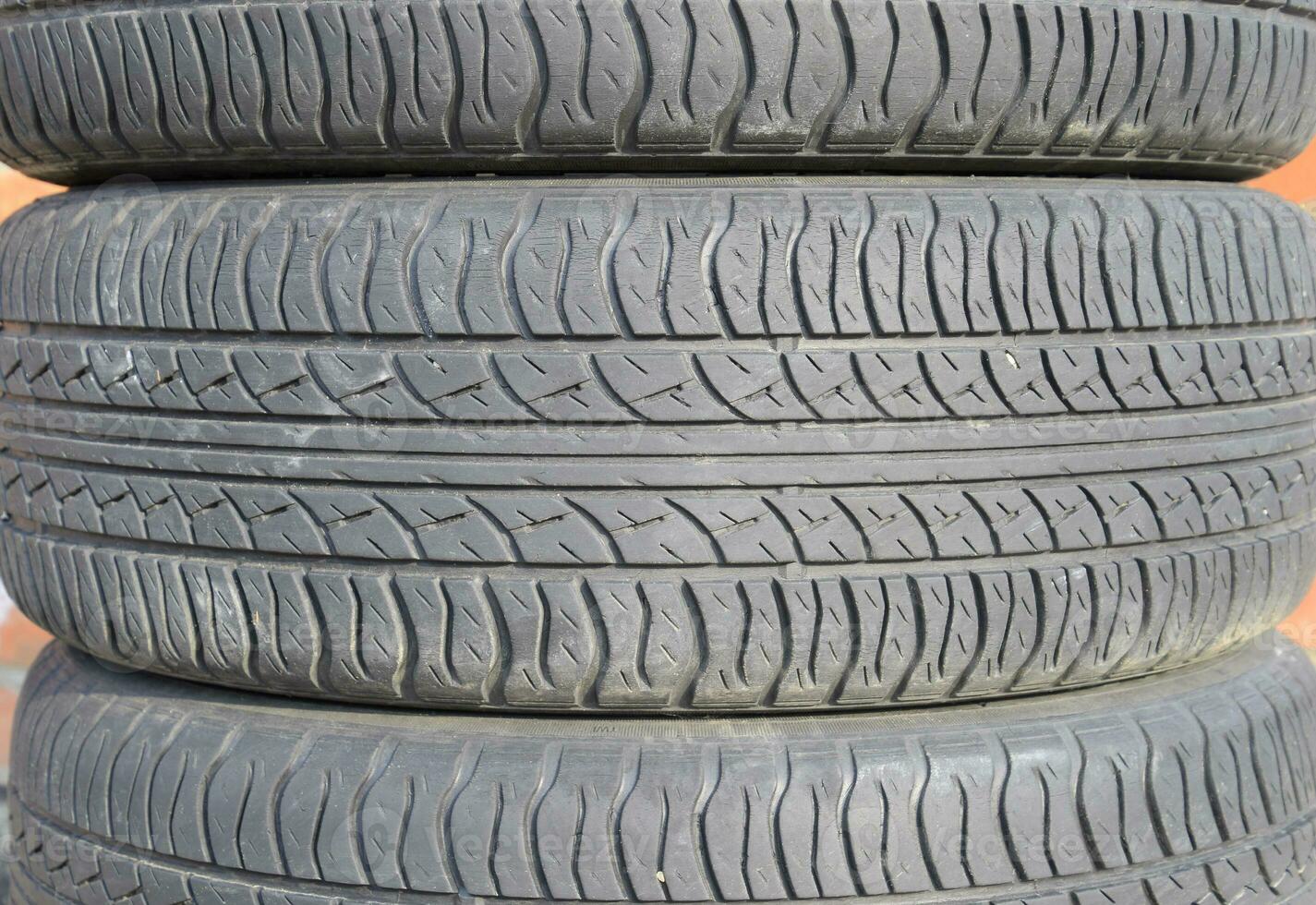 The background of the tread pattern of the car wheel. Rubber tir photo