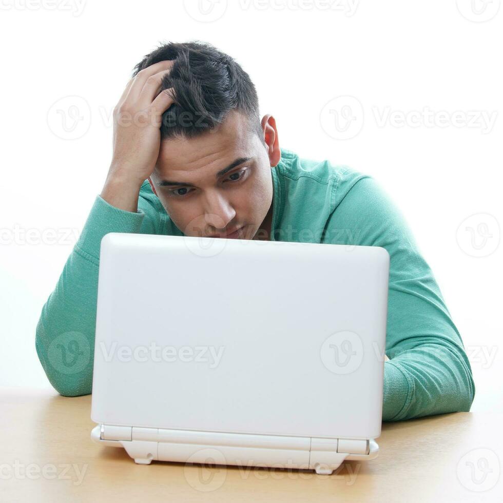 young man staring at netbook photo