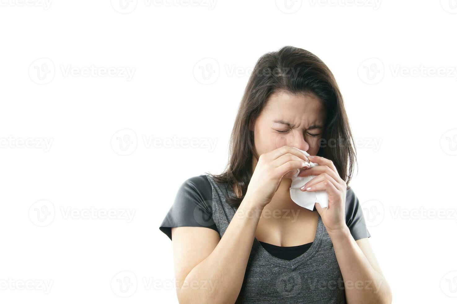 young woman blowing nose photo