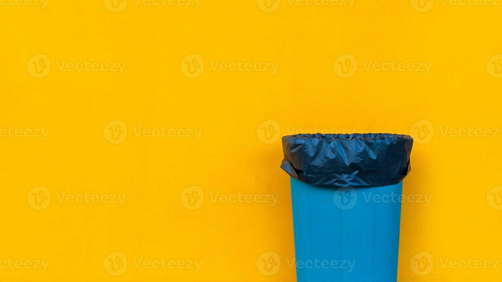 Garbage bin on yellow background, Ecological concept Reduce, reuse, recycle, ecological metaphor for ecological waste management and sustainable and economical lifestyle. photo