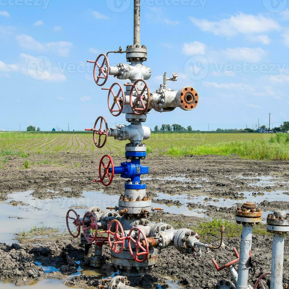 Oil well after repair in mud and puddles. photo