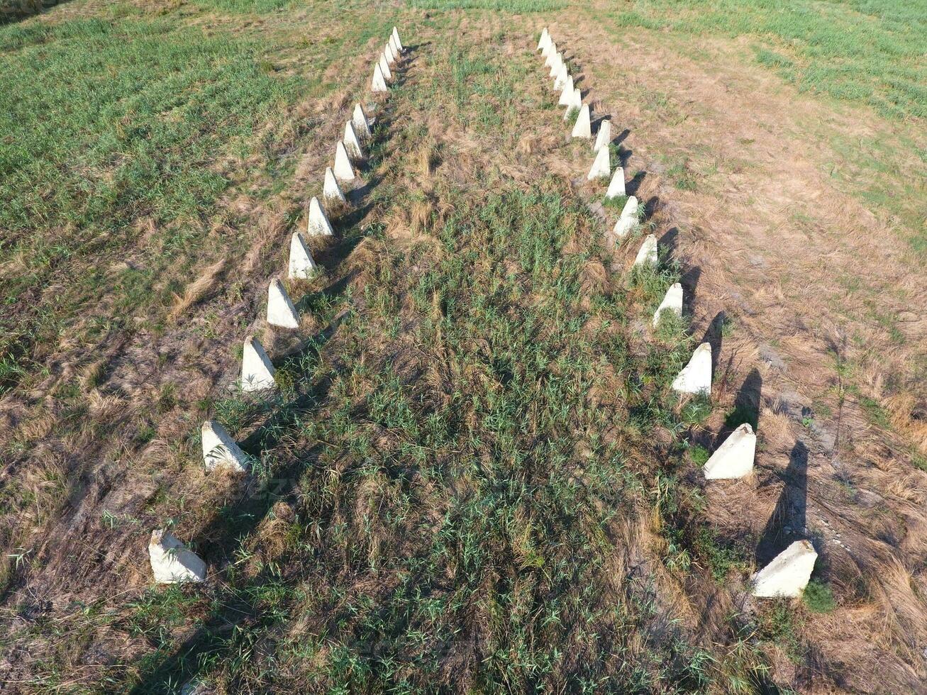 The ruins of the old farm. Cones column base of the wall. Abandoned and ruined buildings photo