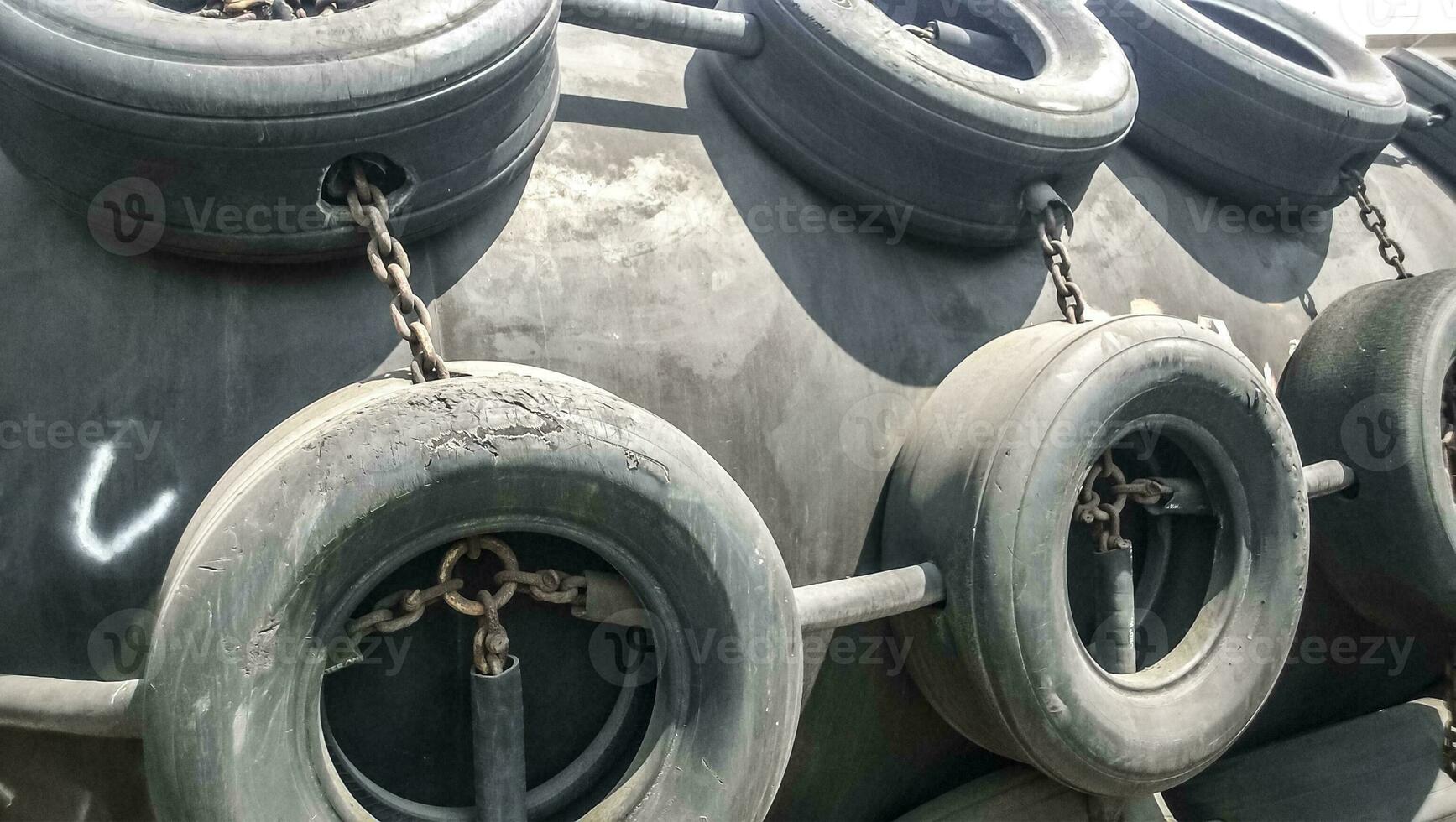 A shockproof buoy to protect the deck of the port and cargo ships from collisions. The buoy is made of rubber backing, covered with wheel protectors photo