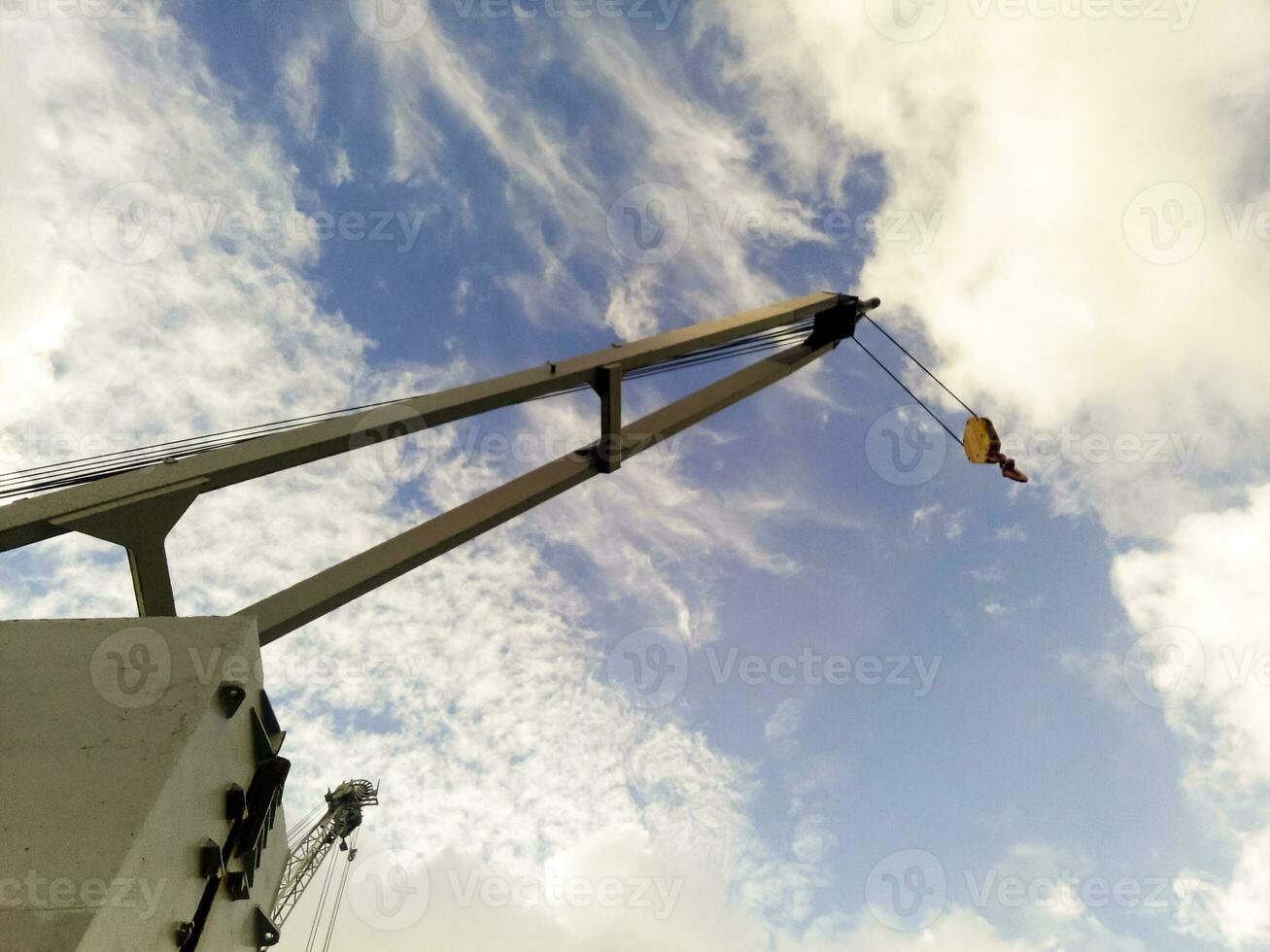 View from the top to the top of the port tower crane. Industrial photo