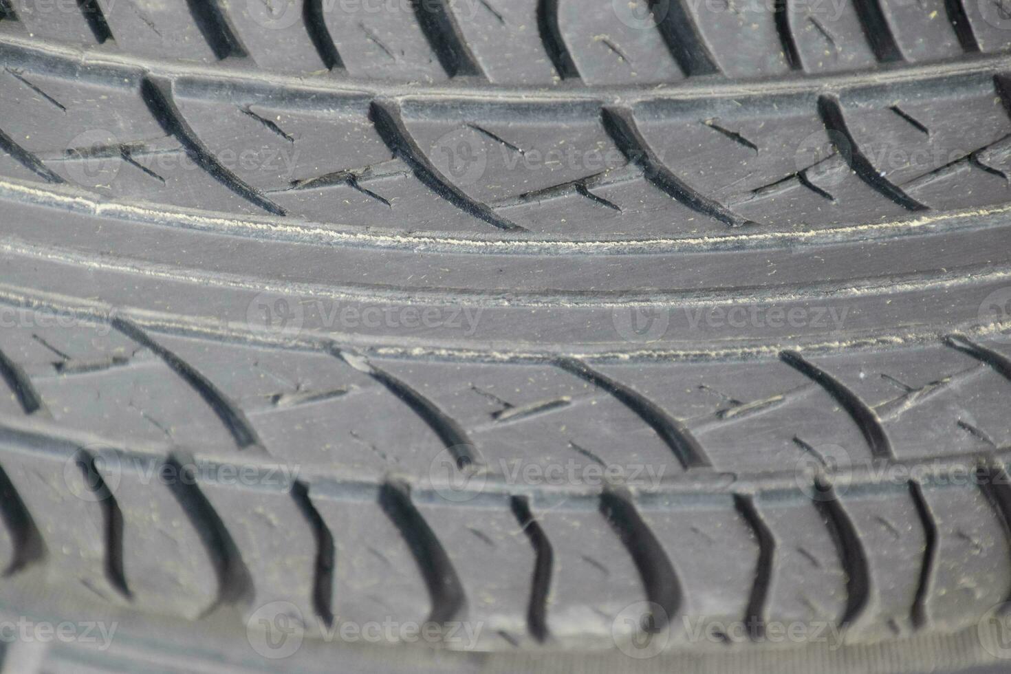 The background of the tread pattern of the car wheel. Rubber tir photo