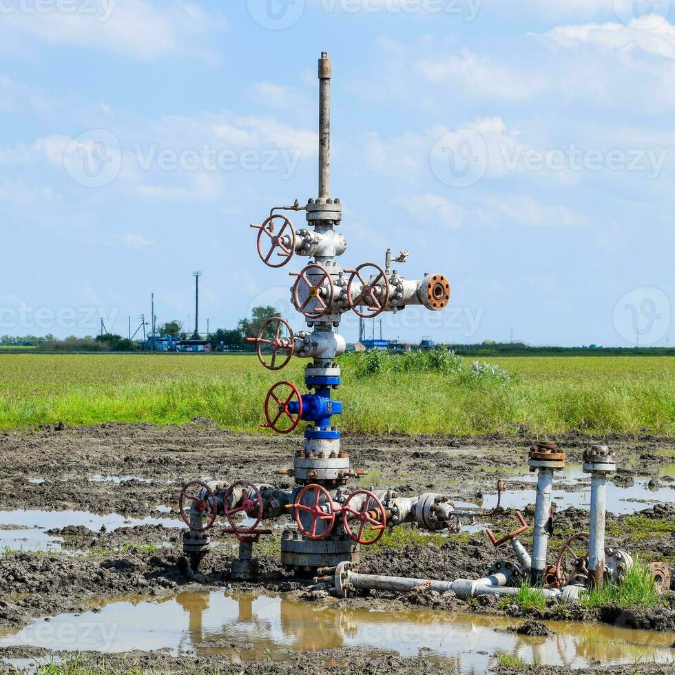 Oil well after repair in mud and puddles. photo