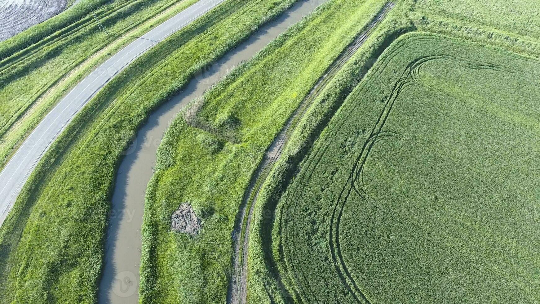 The top view of the wheat field and the channel of the irrigation system. Shooting from a drone. photo