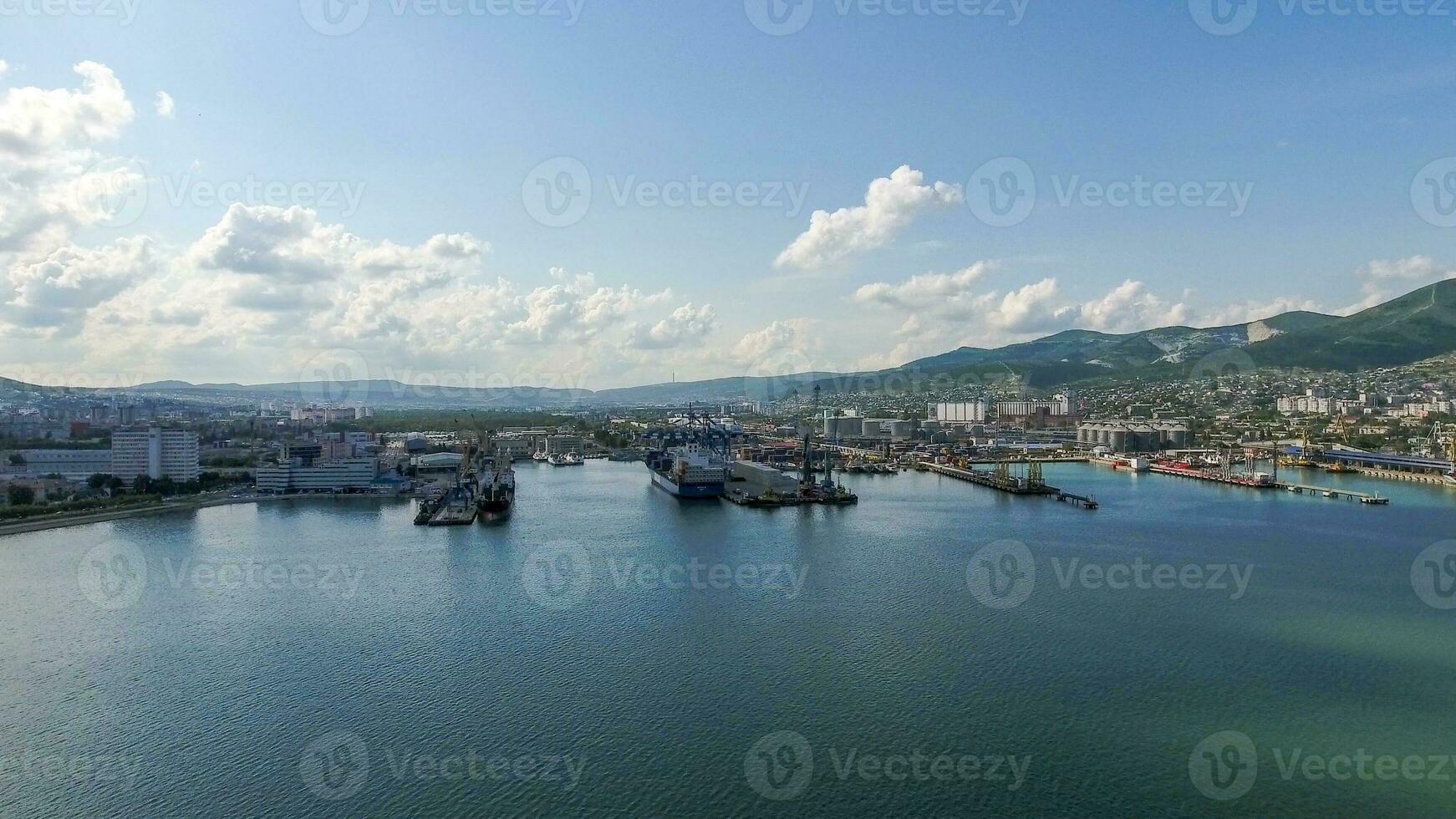 Industrial seaport, top view. Port cranes and cargo ships and barges. photo