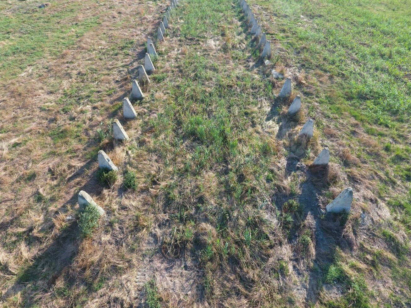 The ruins of the old farm. Cones column base of the wall. Abandoned and ruined buildings photo