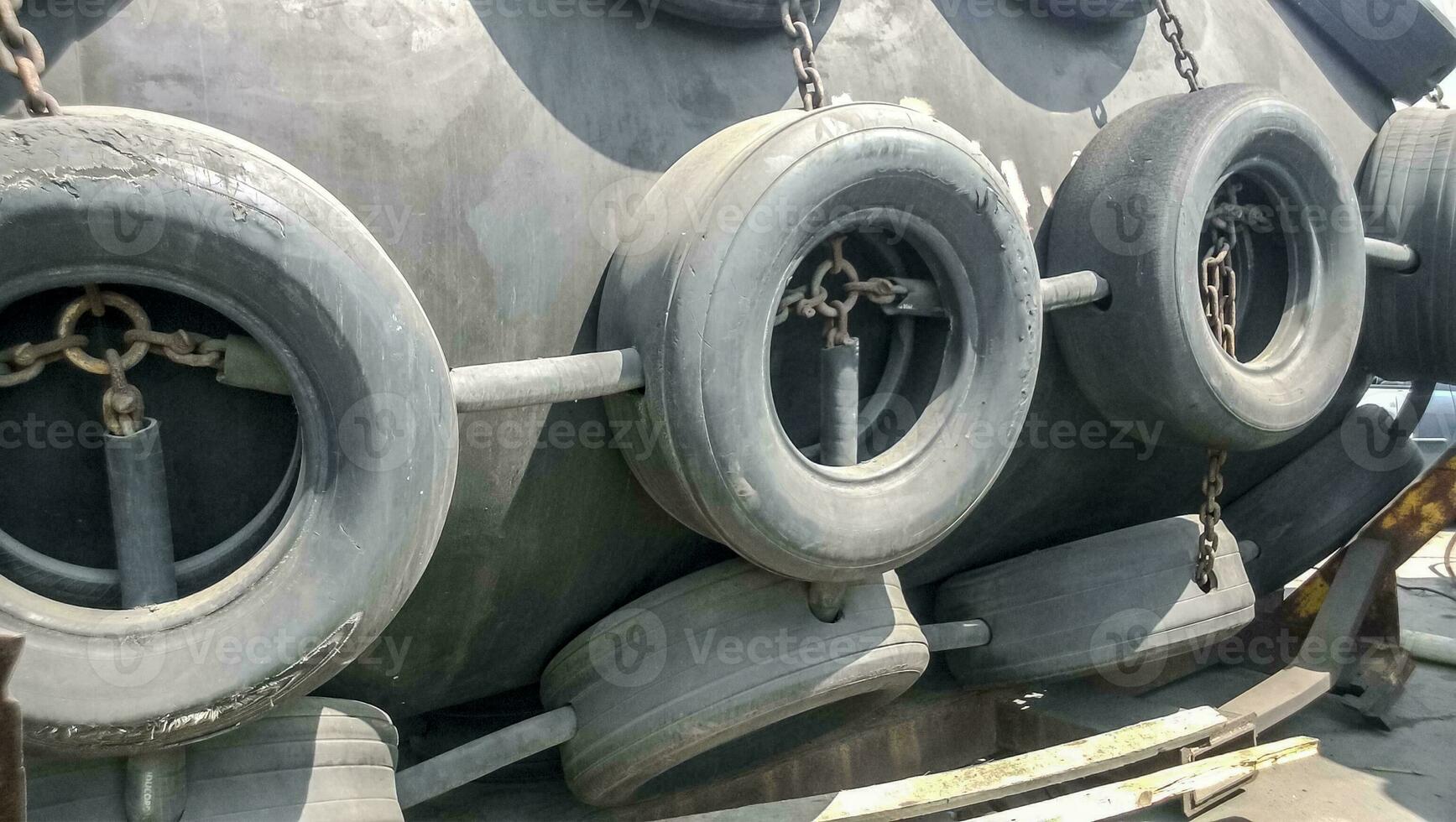 A shockproof buoy to protect the deck of the port and cargo ships from collisions. The buoy is made of rubber backing, covered with wheel protectors photo