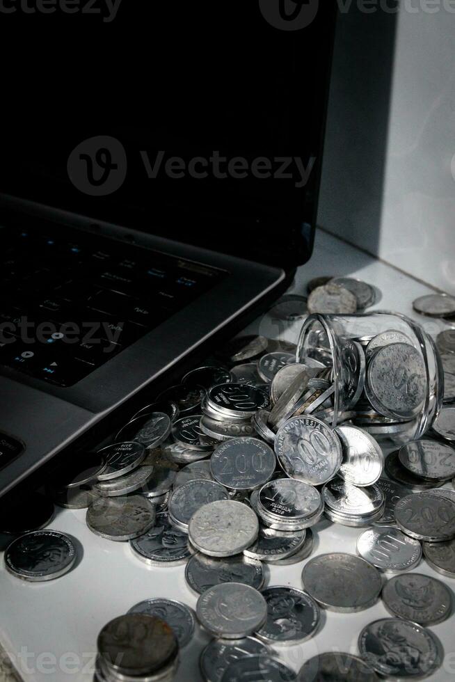 Coin Indonesian rupiah and laptop photo