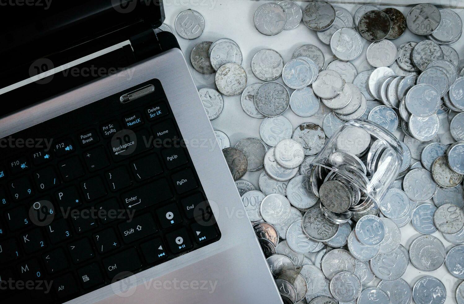 Coin Indonesian rupiah and laptop photo