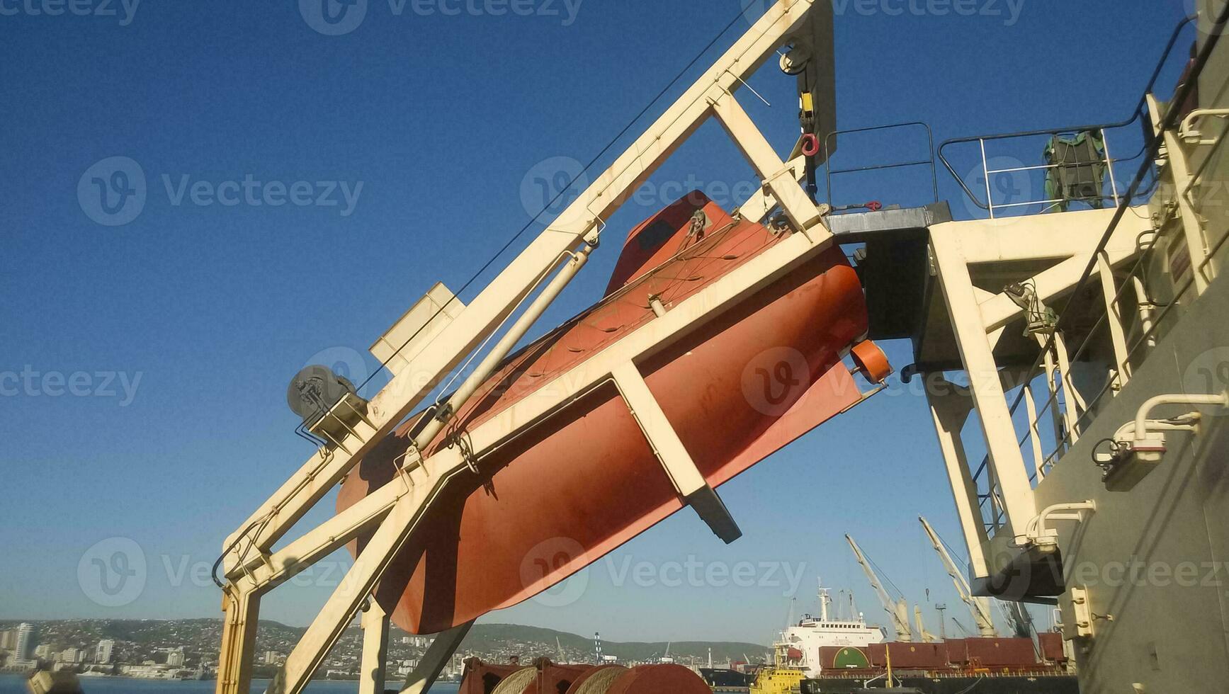 A lifeboat in case of an accident in the port or on a ship. The orange boat photo