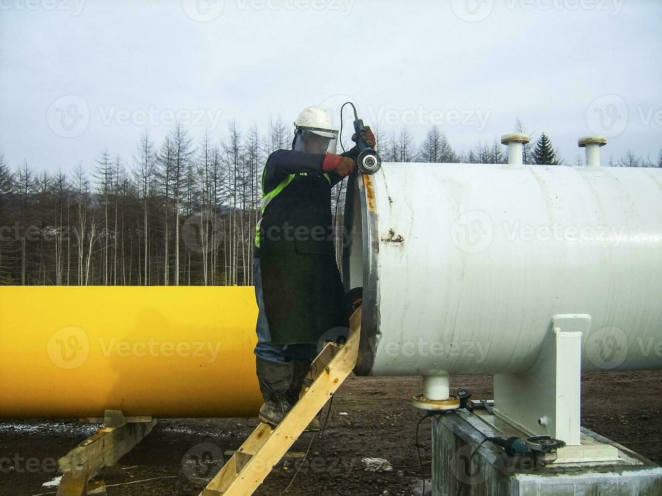 Safety at work. Welding and installation of the pipeline. Indust photo