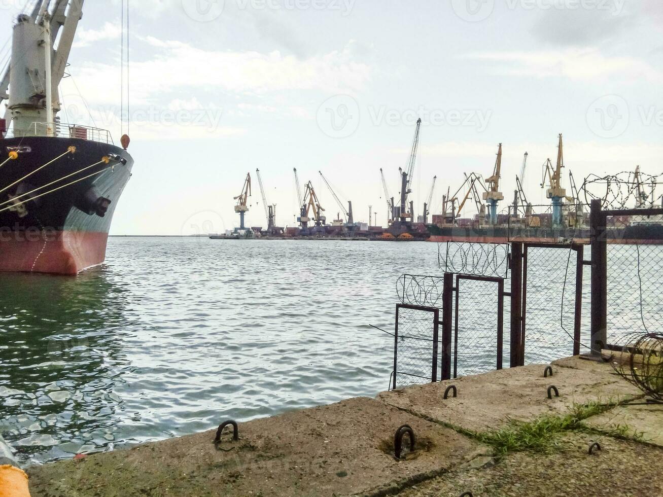 View of the sea and city beach from the port quay. Industrial po photo