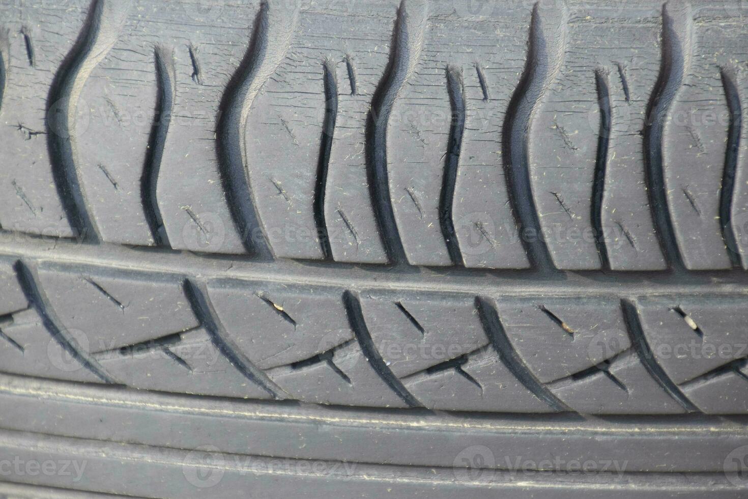 The background of the tread pattern of the car wheel. Rubber tir photo