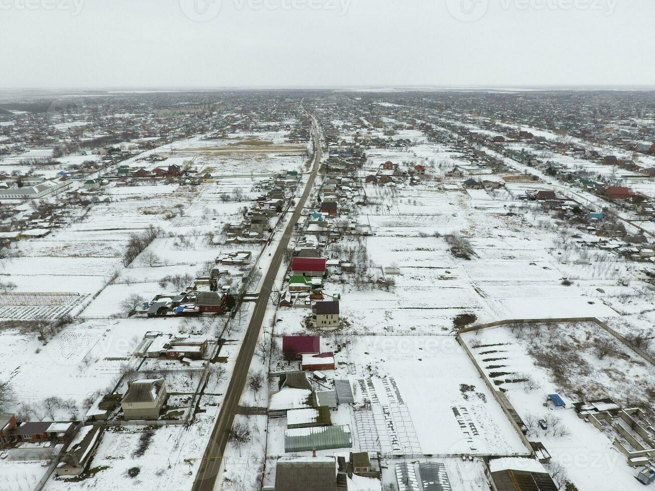 Winter view from the bird's eye view of the village. The streets are covered with snow photo