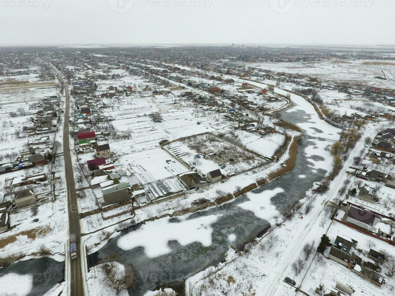 Winter view from the bird's eye view of the village. The streets are covered with snow photo