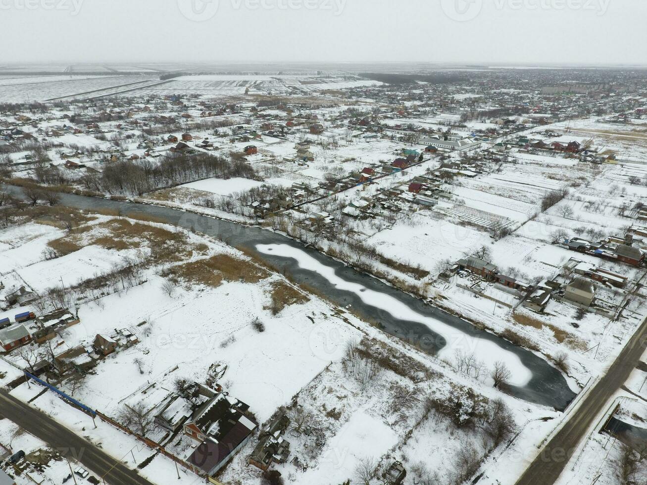 Winter view from the bird's eye view of the village. The streets are covered with snow photo