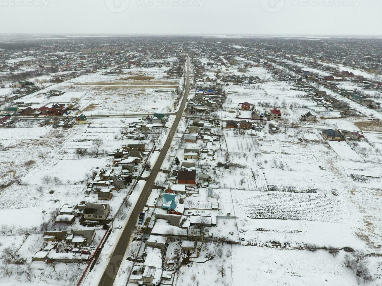 Winter view from the bird's eye view of the village. The streets are covered with snow photo