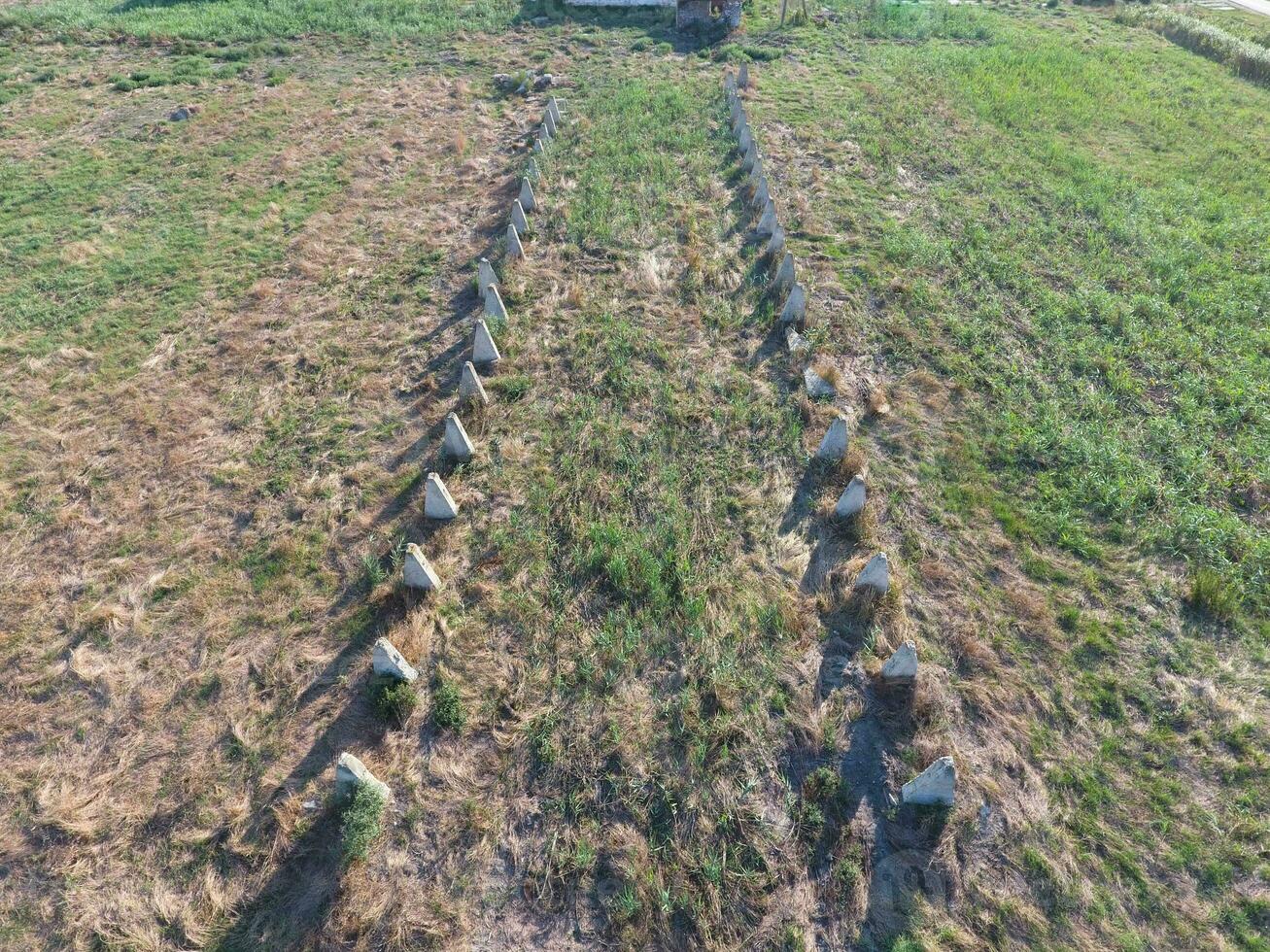 The ruins of the old farm. Cones column base of the wall. Abandoned and ruined buildings photo