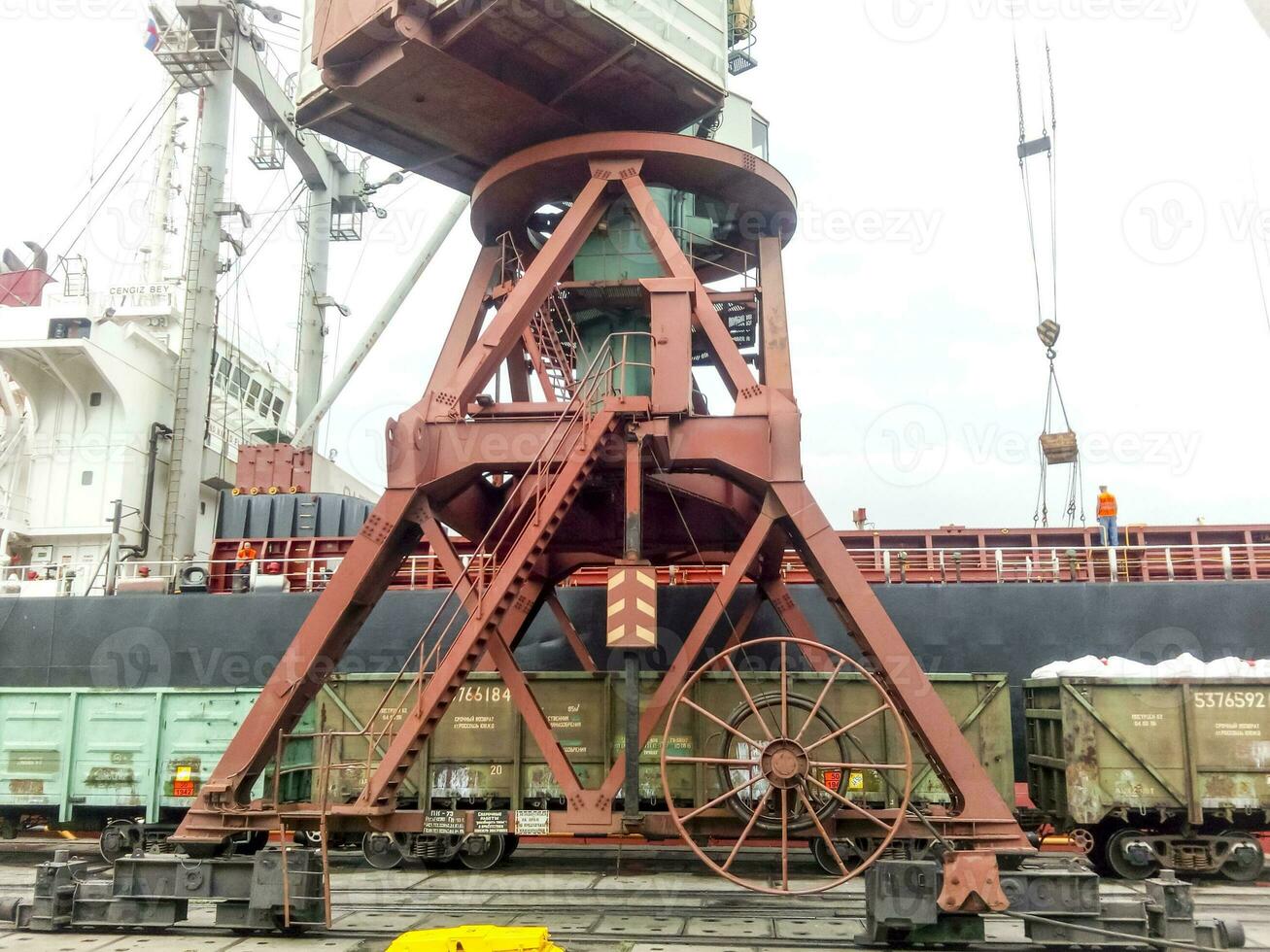 Loaded freight cars in the port. Passage of cars under the tower photo