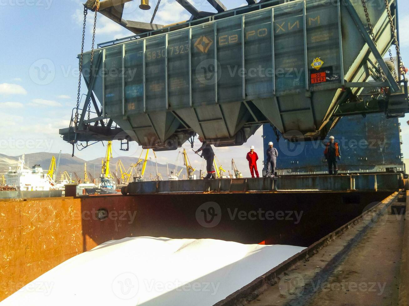 Wagon of the hopper for unloading on a cargo ship. Lifting operations in the port. photo