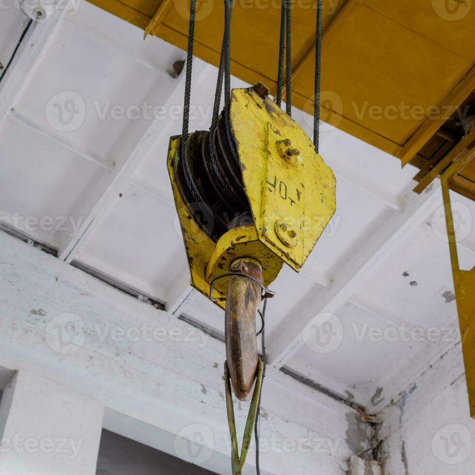 Hoist with winch and hook. A tool for moving goods in a producti photo