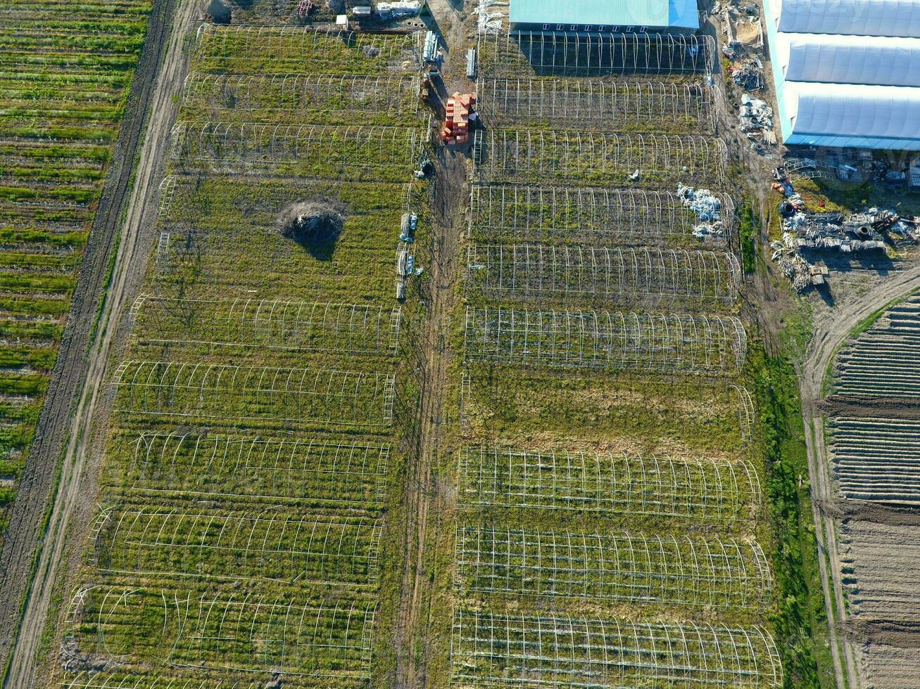 Frameworks of greenhouses, top view. Construction of greenhouses in the field. Agriculture, agrotechnics of closed ground photo