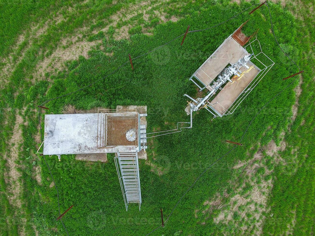 Equipment of an oil well. A tank with methanol near the oil well. Shutoff valves and service equipment photo