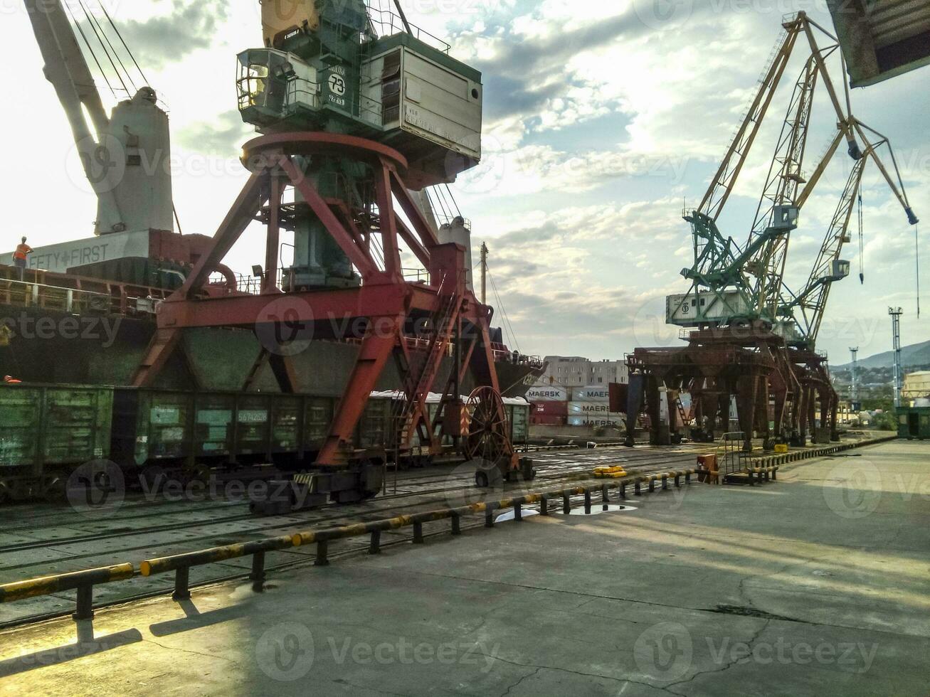 Loaded freight cars in the port. Passage of cars under the tower photo