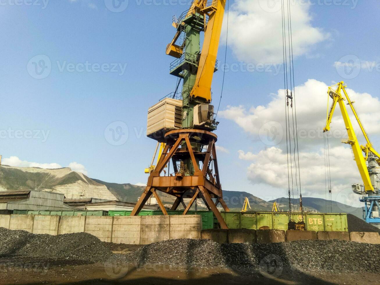 Cargo industrial port, port cranes. Loading of anthracite. Transportation of coal. Heap of coal photo