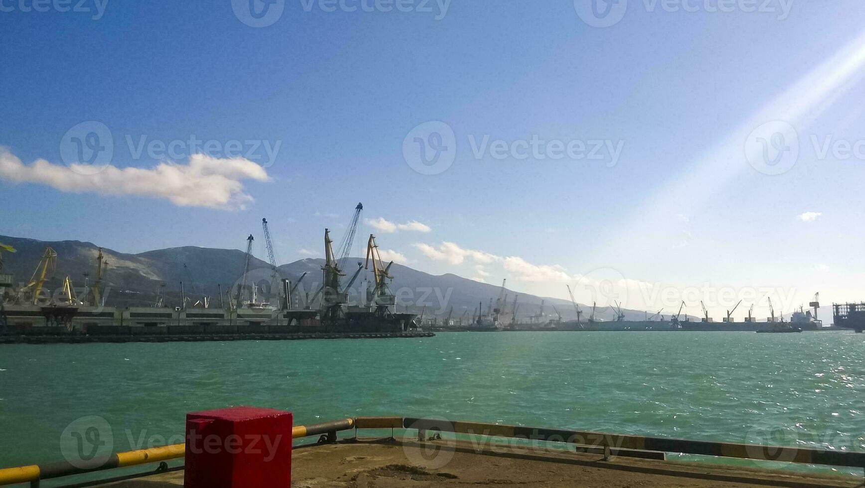 Port landscape. View of the industrial port. The sea, port cranes and ships photo