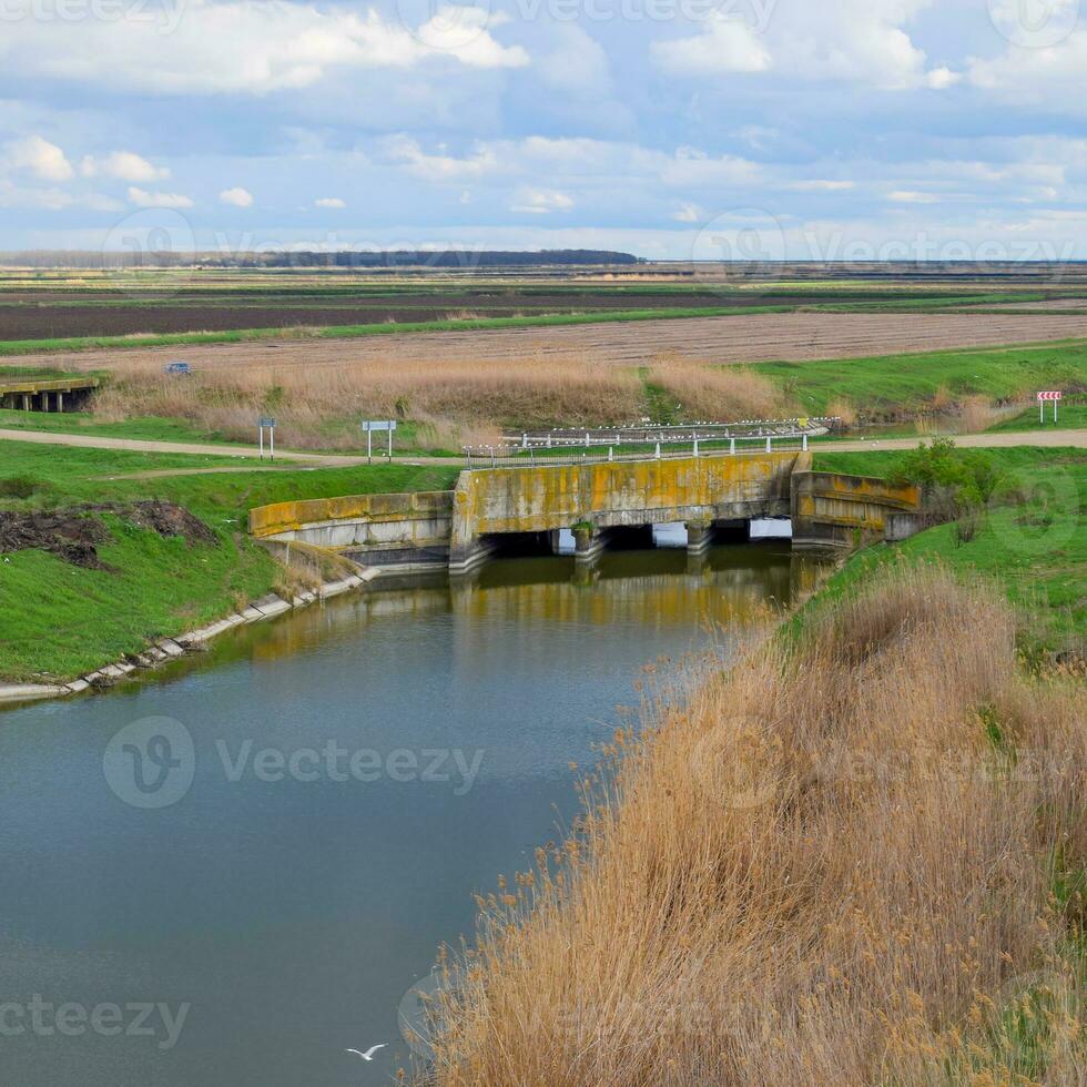 Bridges through irrigation canals. Rice field irrigation system photo